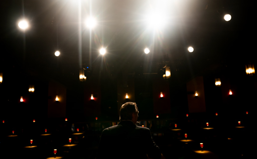 Man Hosting Event On Stage At Alhambra Theatre